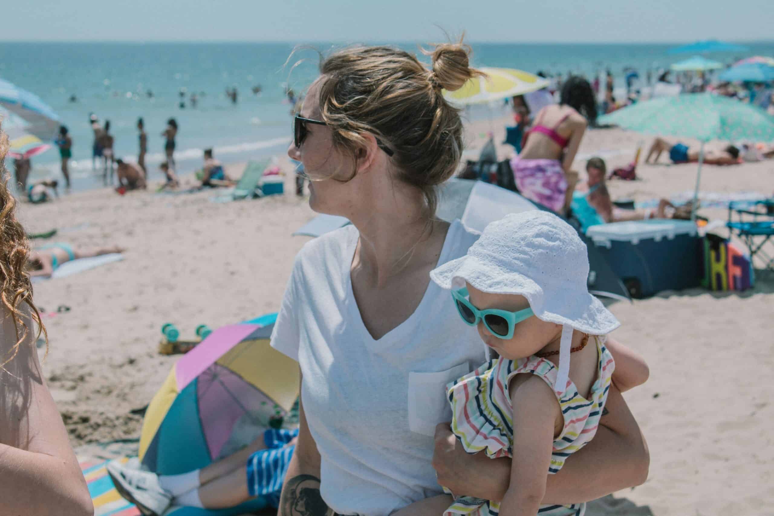 Women at beach holding baby