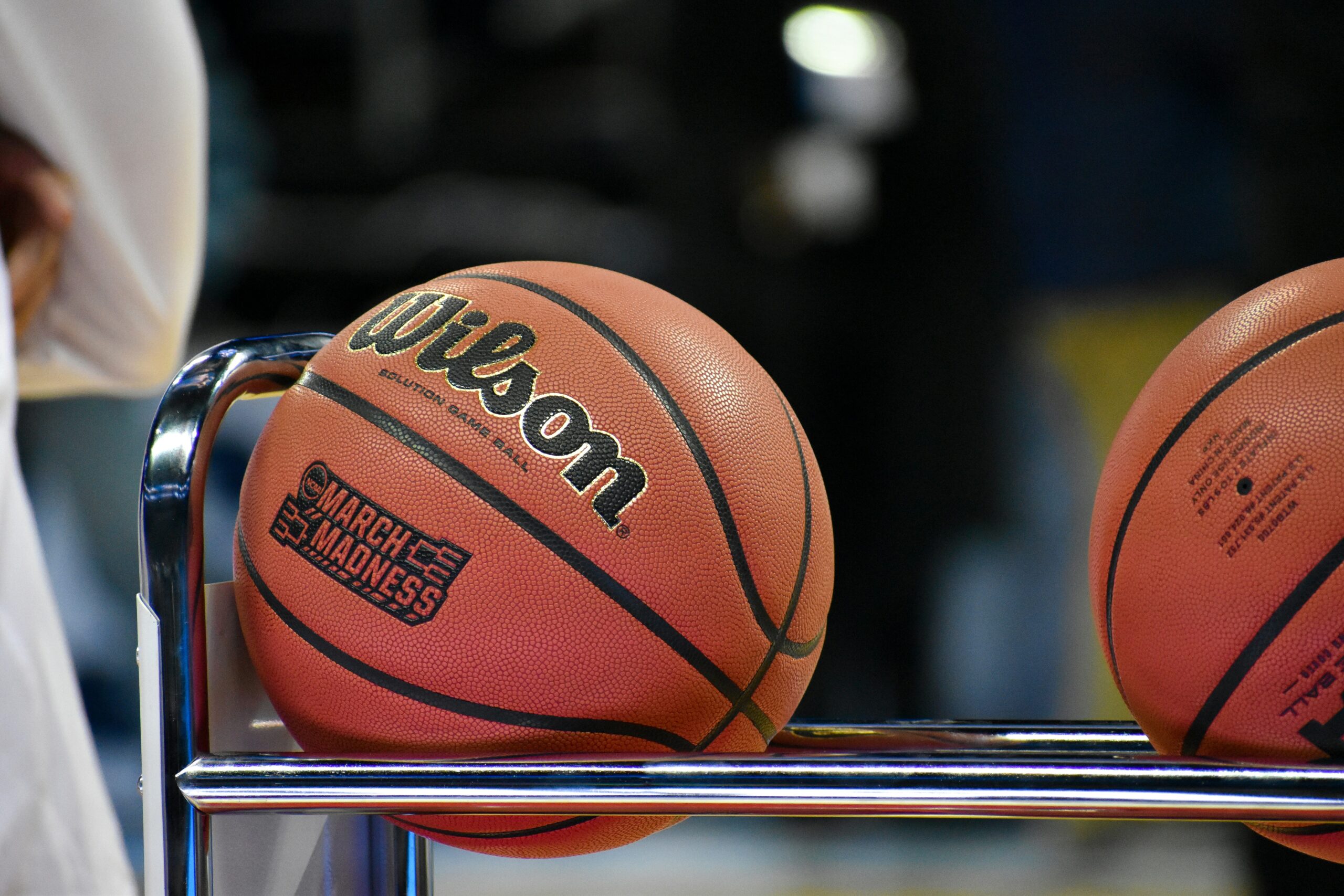 Basketballs labeled March Madness on a rack